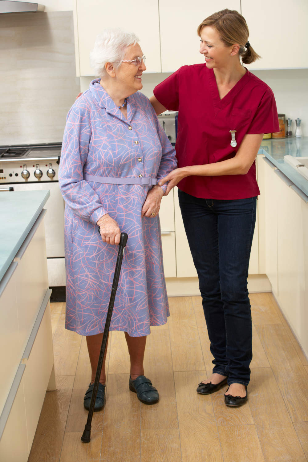 Senior woman and caregiver in kitchen