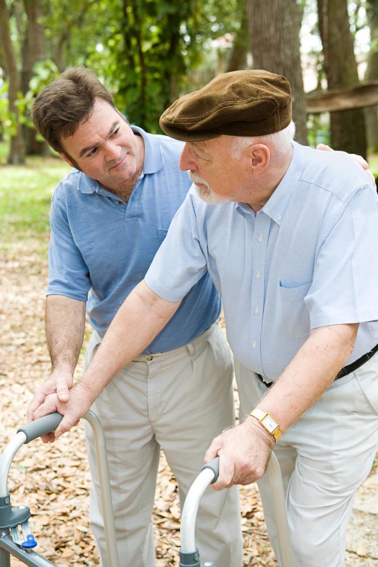elderly man getting help with ambulation